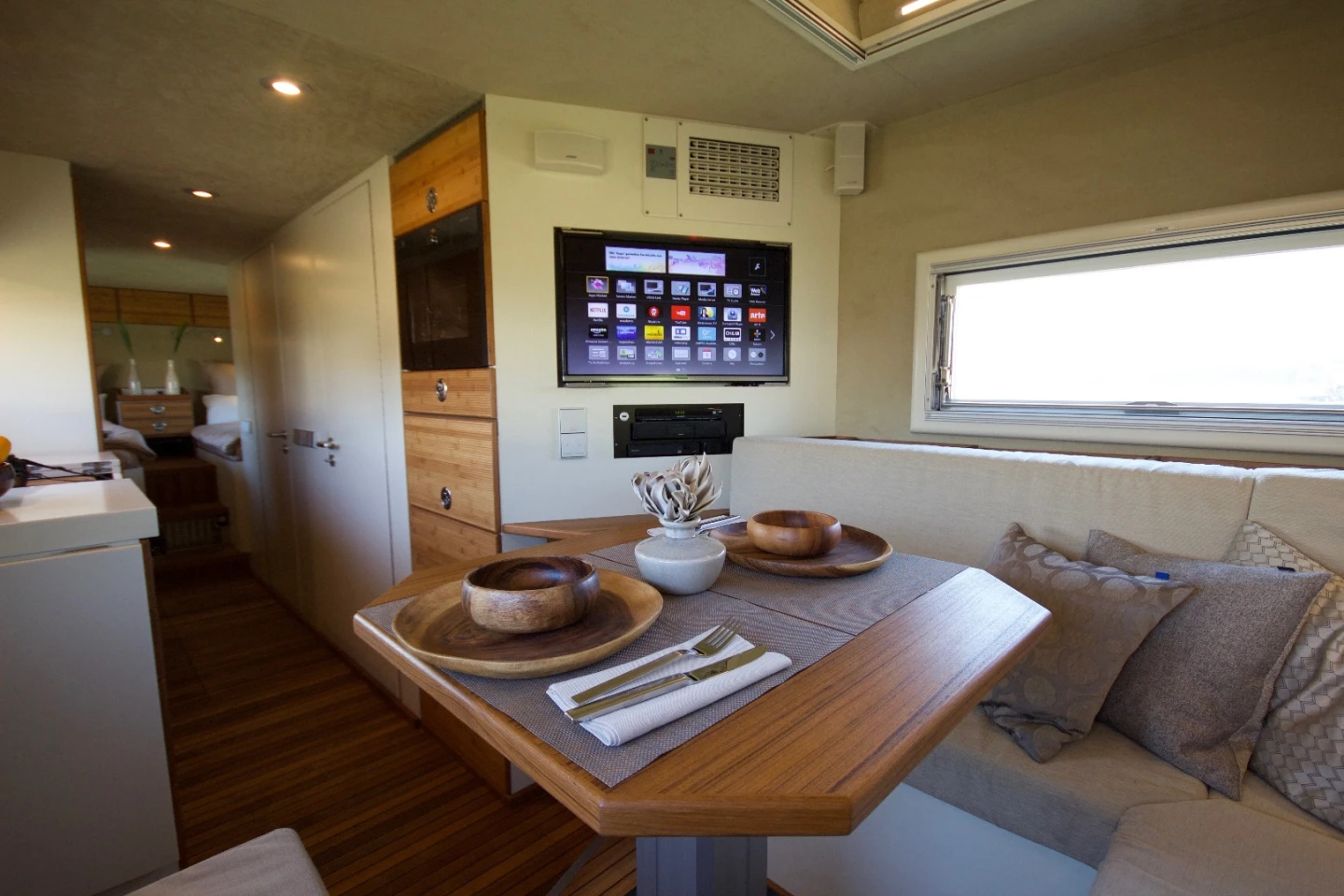 The dining/lounge includes seating for four to five people and an entertainment center. The sofa and table convert to a bed