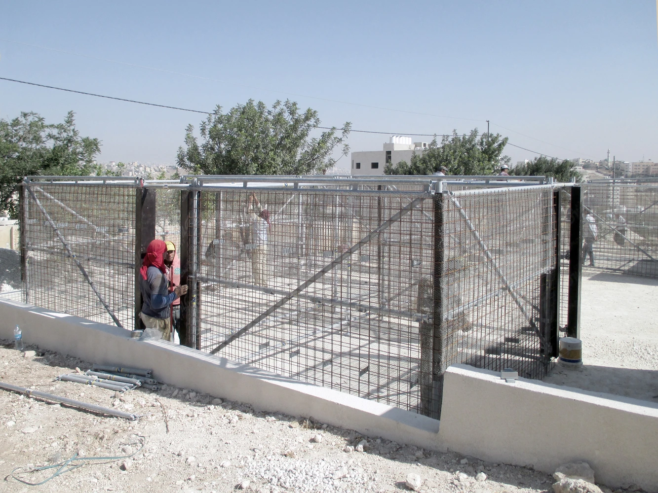 Fencing is added to hold gravel and sand