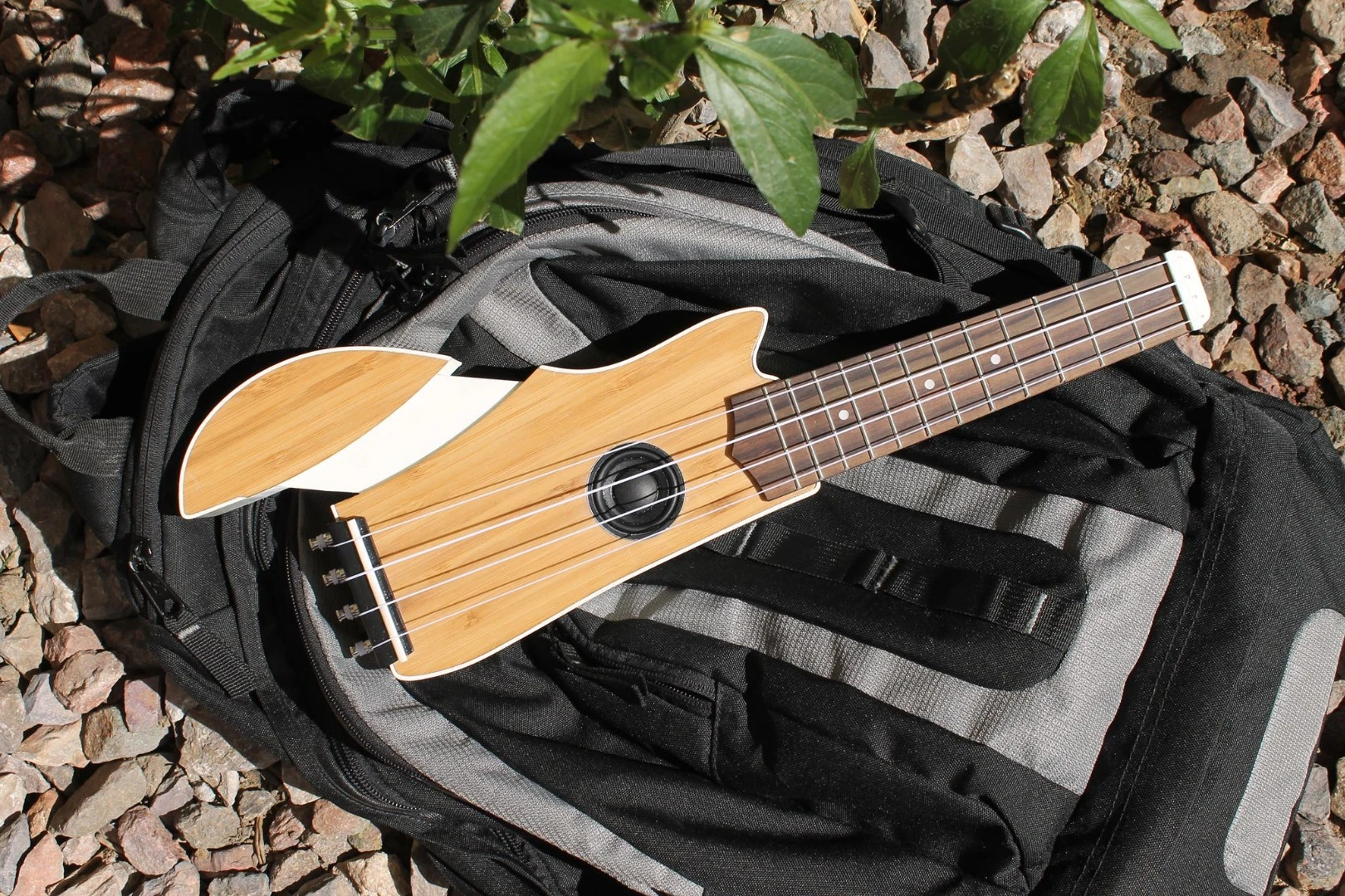 The Ava travel ukulele should easily fit inside a backpack