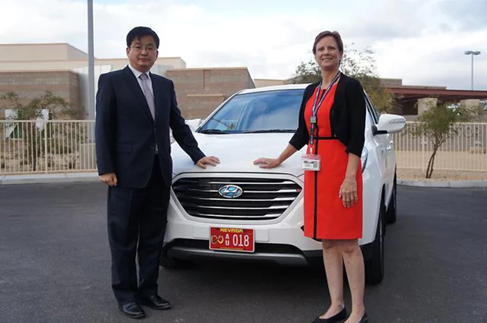 Tae-Won Lim, Vice President, Central Advanced Research and Engineering Institute of Hyundai Motor Group with Deputy Administrator of Nevada Department of Motor Vehicles, Robin Allender in front of a fully autonomous Tucson FCV
