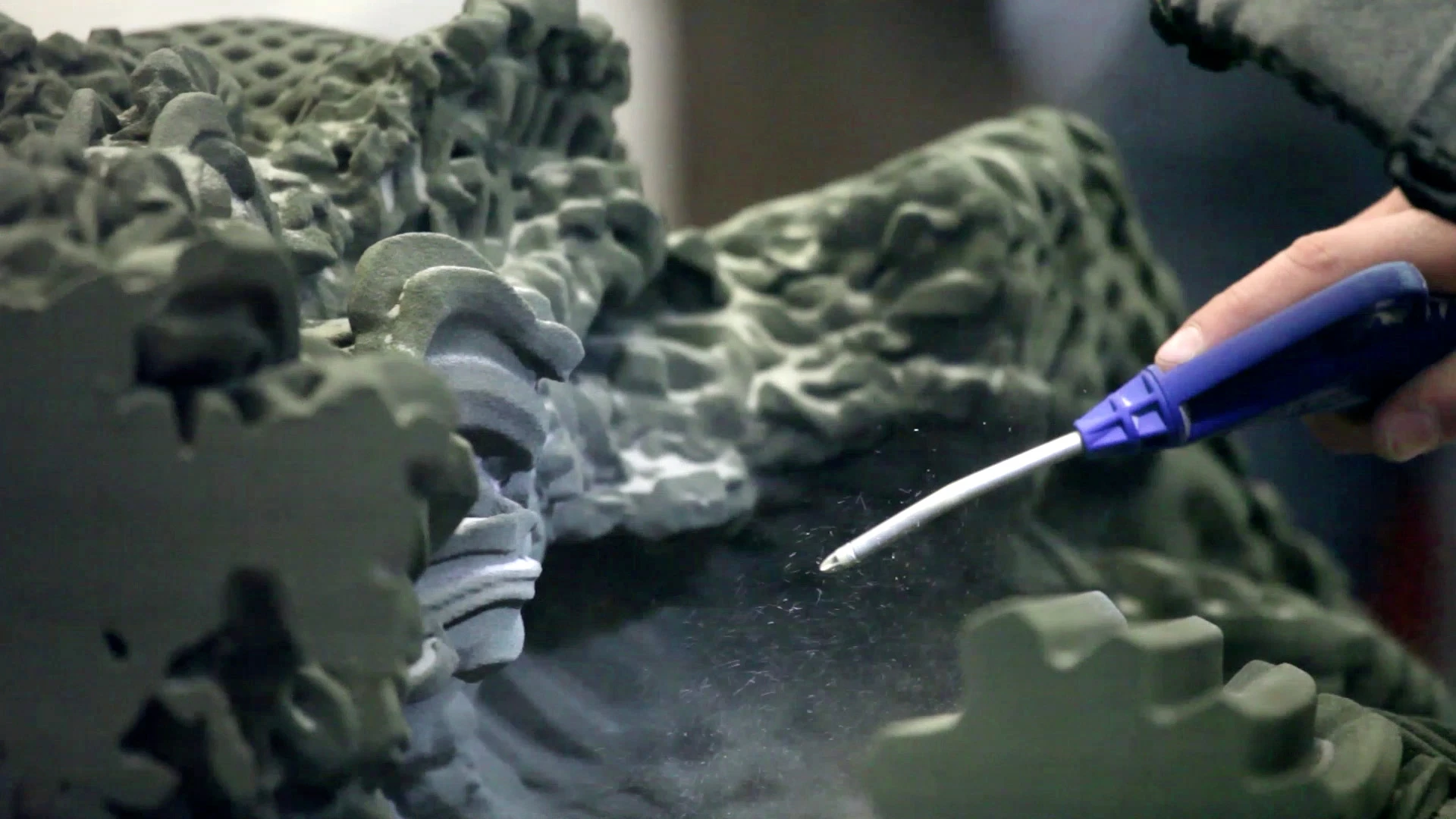 Removing the sand from the printed part (Photo: Demetris Shammas / Achilleas Xydis)