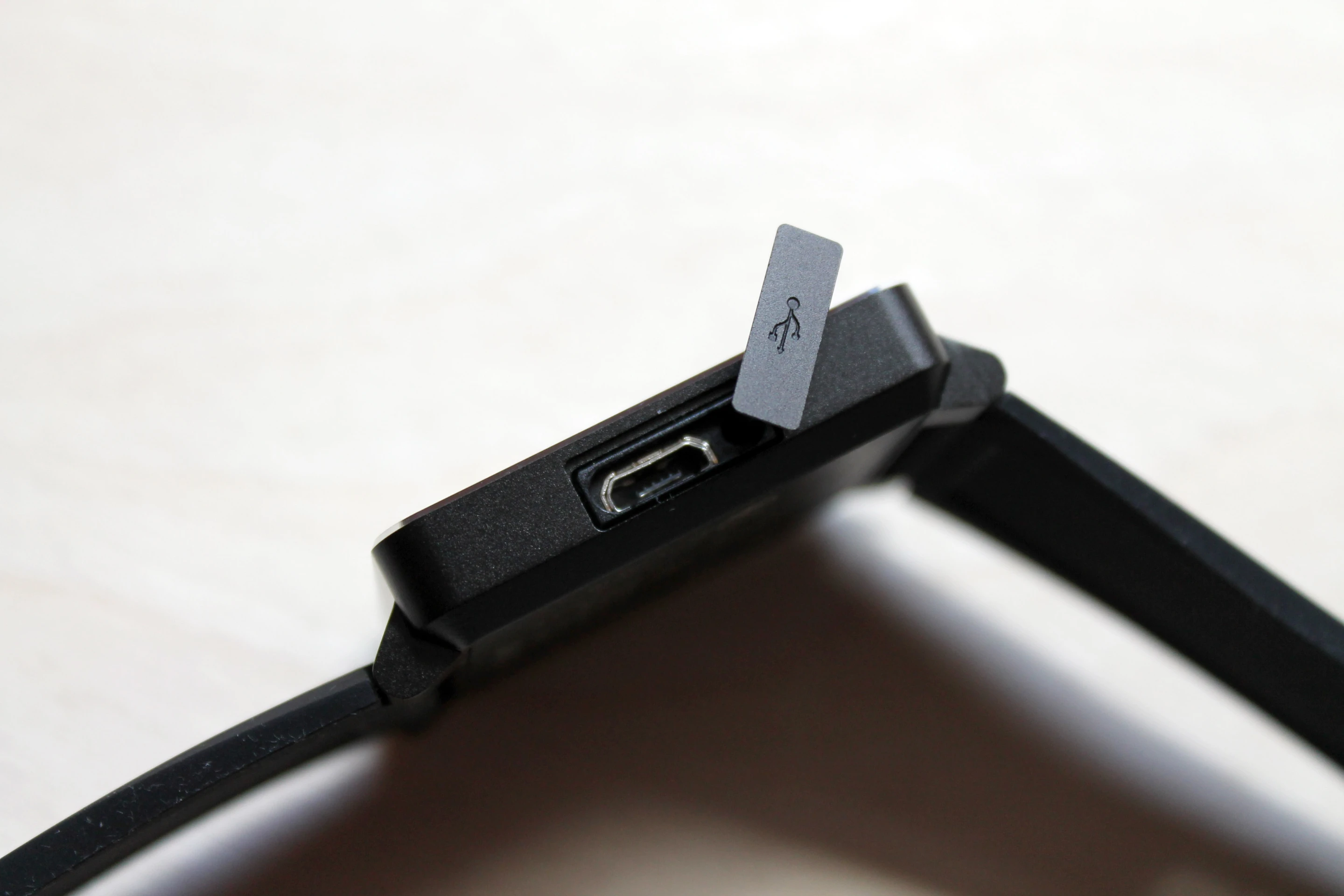 Flip open the cover and insert the included microUSB cable to charge