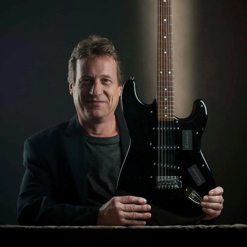 Los Angeles industrial designer and keen guitarist Mark Andersen with his Touchmark Guitar