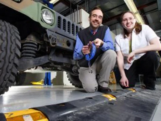 Purdue associate professor of mechanical engineering, Douglas Adams, and graduate student Tiffany DiPetta with the speed bumplike "diagnostic cleat"Pic credit: Purdue News Service photo/Andrew Hancock