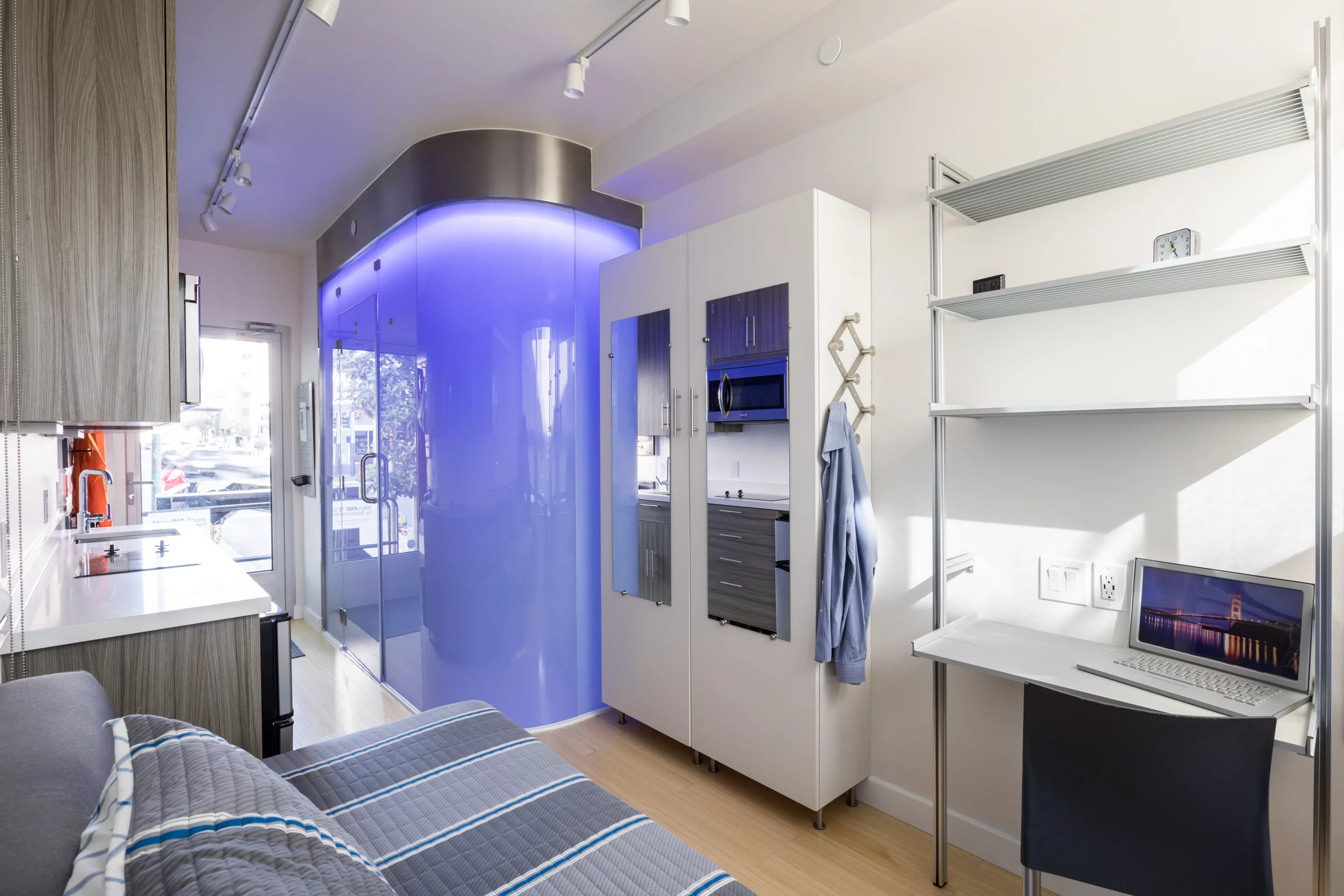 The MicroPAD interiors include a bathroom with shower and toilet inside, a kitchenette, bed, plenty of storage space, and a desk