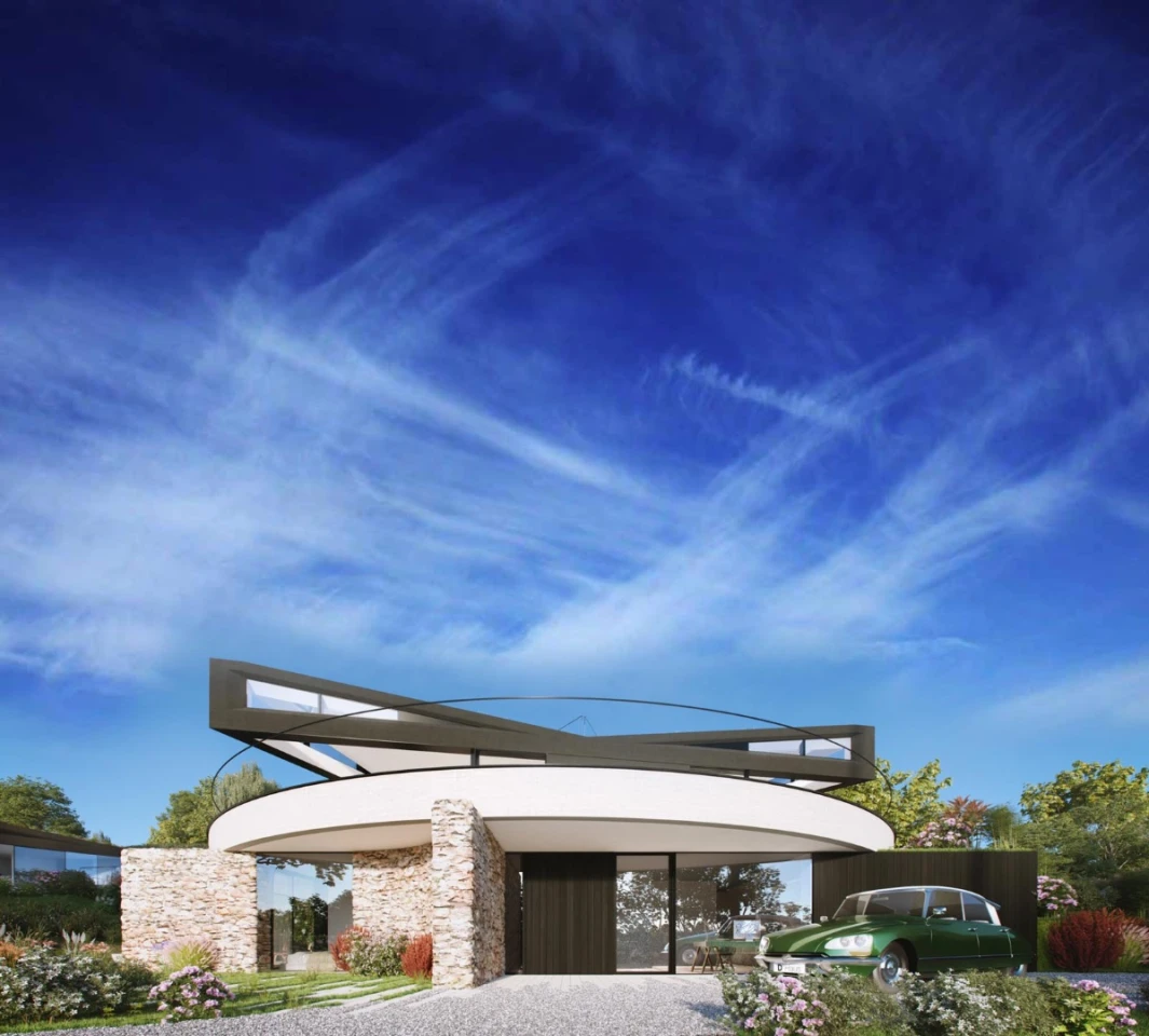 The circular base of the house resembles a plinth that the triangular top sits on top of
