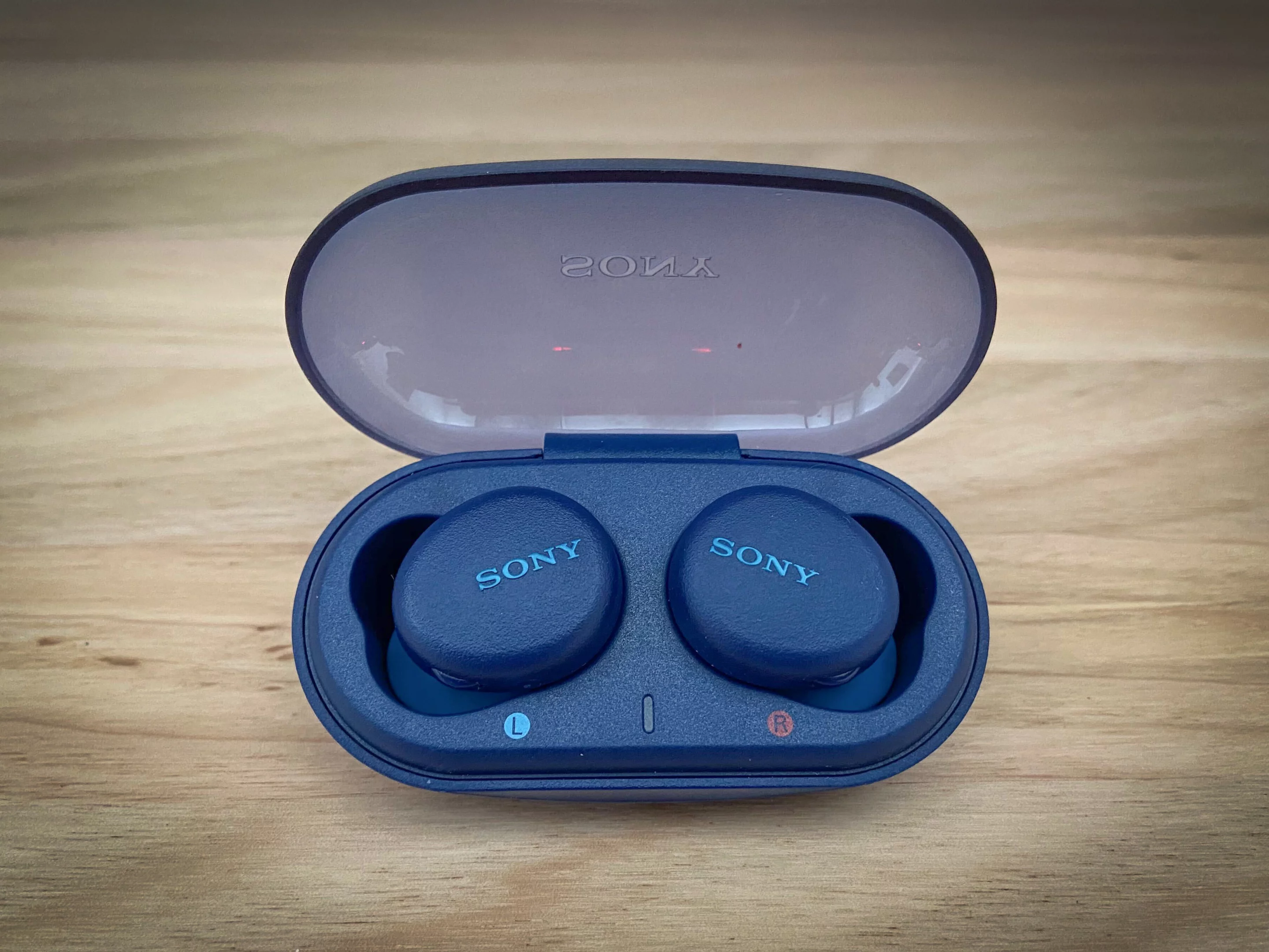 The earbuds sit snugly in the solidly built charging case