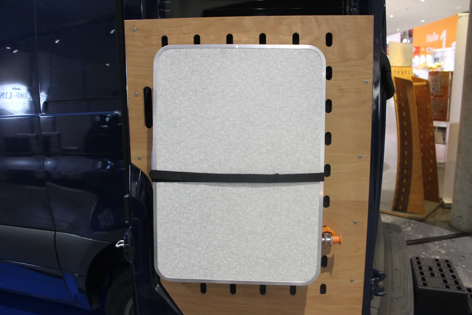 CargoClips paneling on the Cargo Camper City rear doors holds a table in place