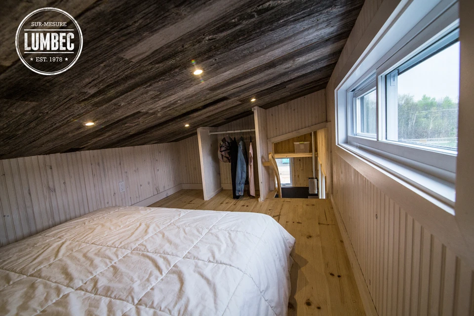 The large loft wth a queen-sized bed and integrated storage