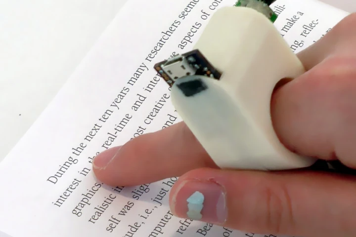 FingerReader uses a built-in camera to scan pieces of text, providing audio feedback to the visually impaired in real-time
