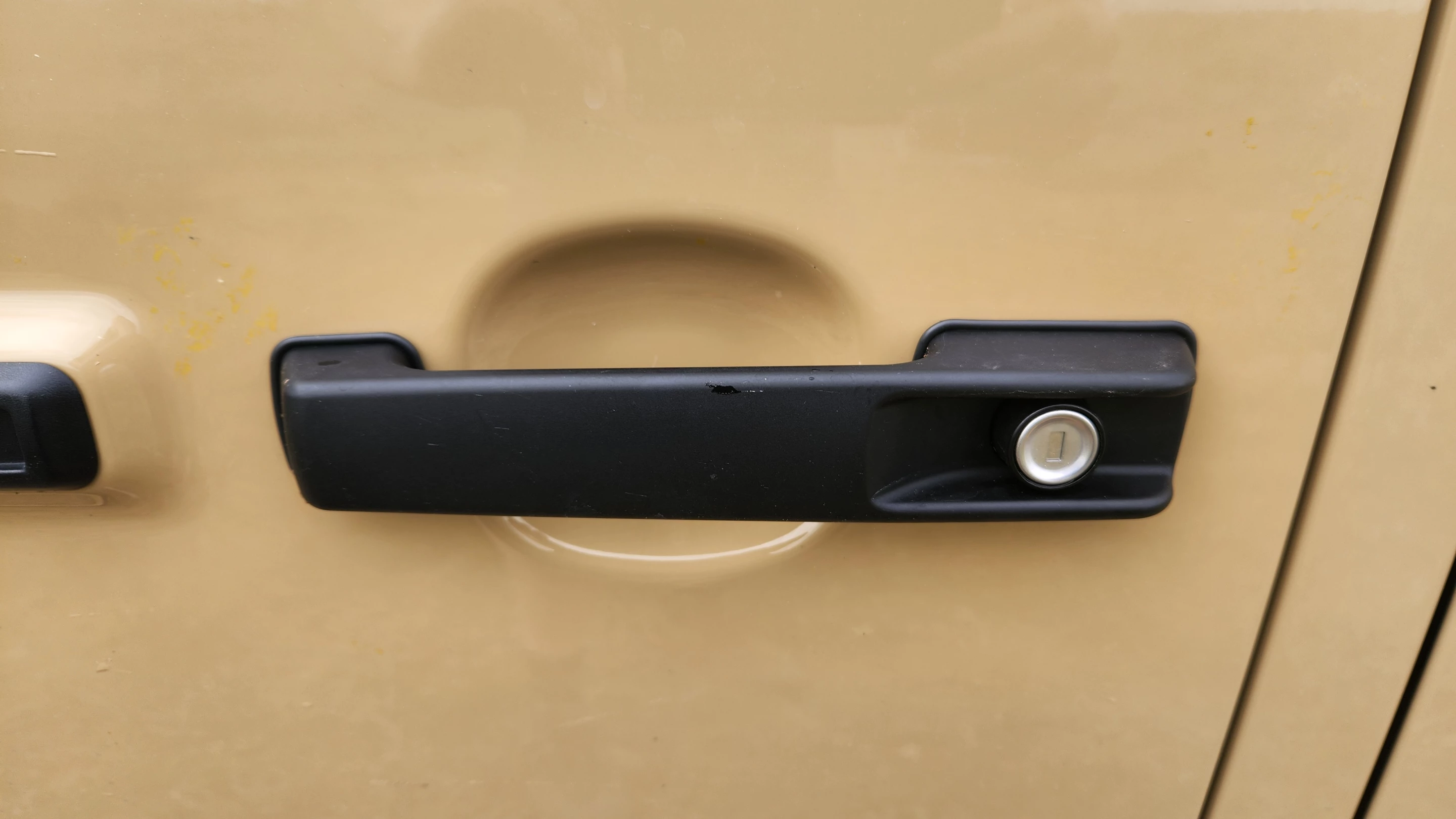 The nostalgic thumb-push handle on a current-generation Mercedes-Benz