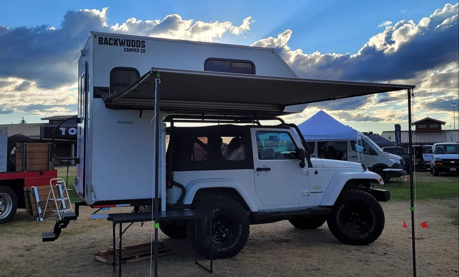 The Backwoods Camper mounts via a customized hitch rack and a roof rack