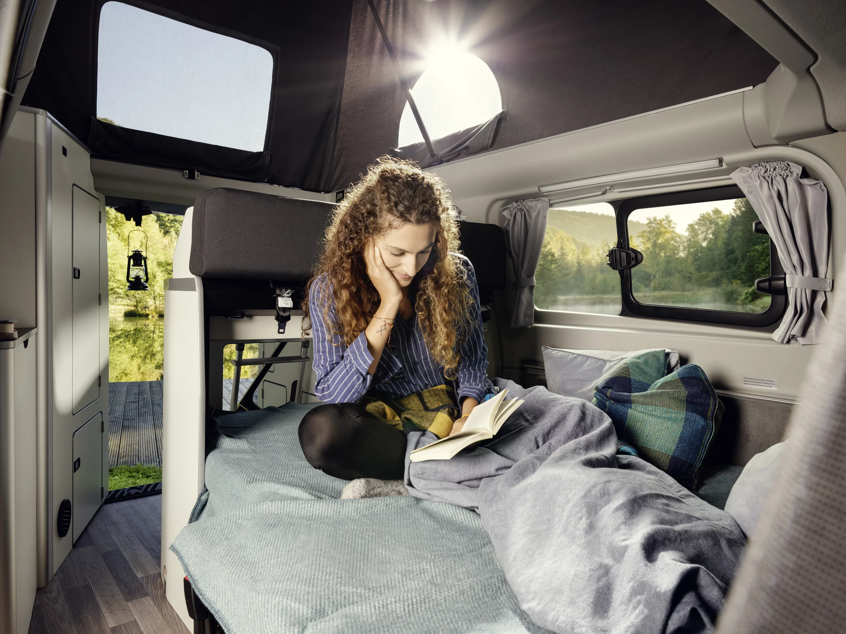 Westfalia splits the Nugget interior more so than in other camper vans, creating a dedicated kitchen, convertible dining area/lounge/bed and upstairs bed
