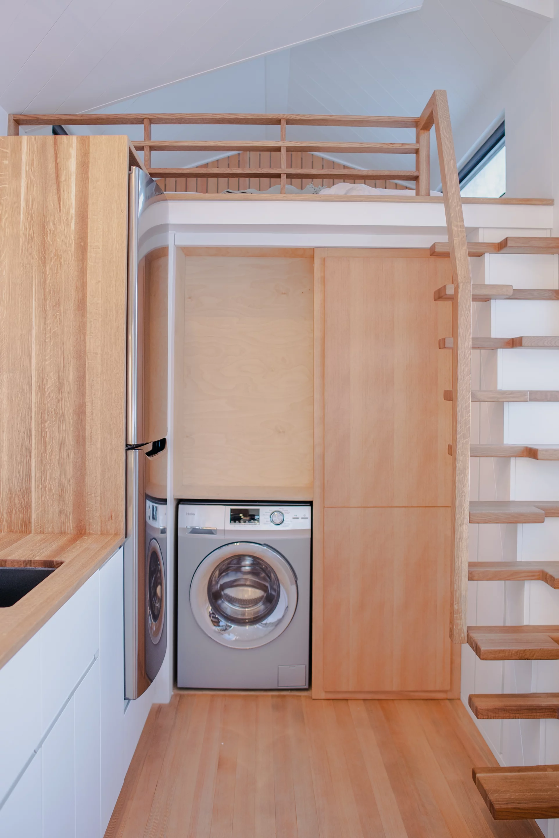 The kitchen hides a European laundry and a secret sliding door that doubles as a pantry