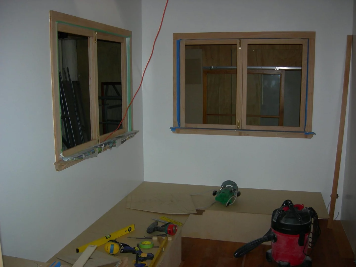 The living room is filled with natural light due to the inclusion of numerous large windows