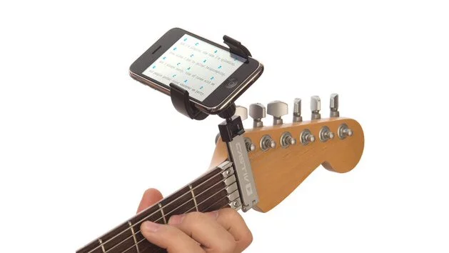 The Guitar Sidekick portable device mount places a smartphone or media players at the end of a guitar's fretboard for comfortable viewing of music notation, tabs, lyrics and so on