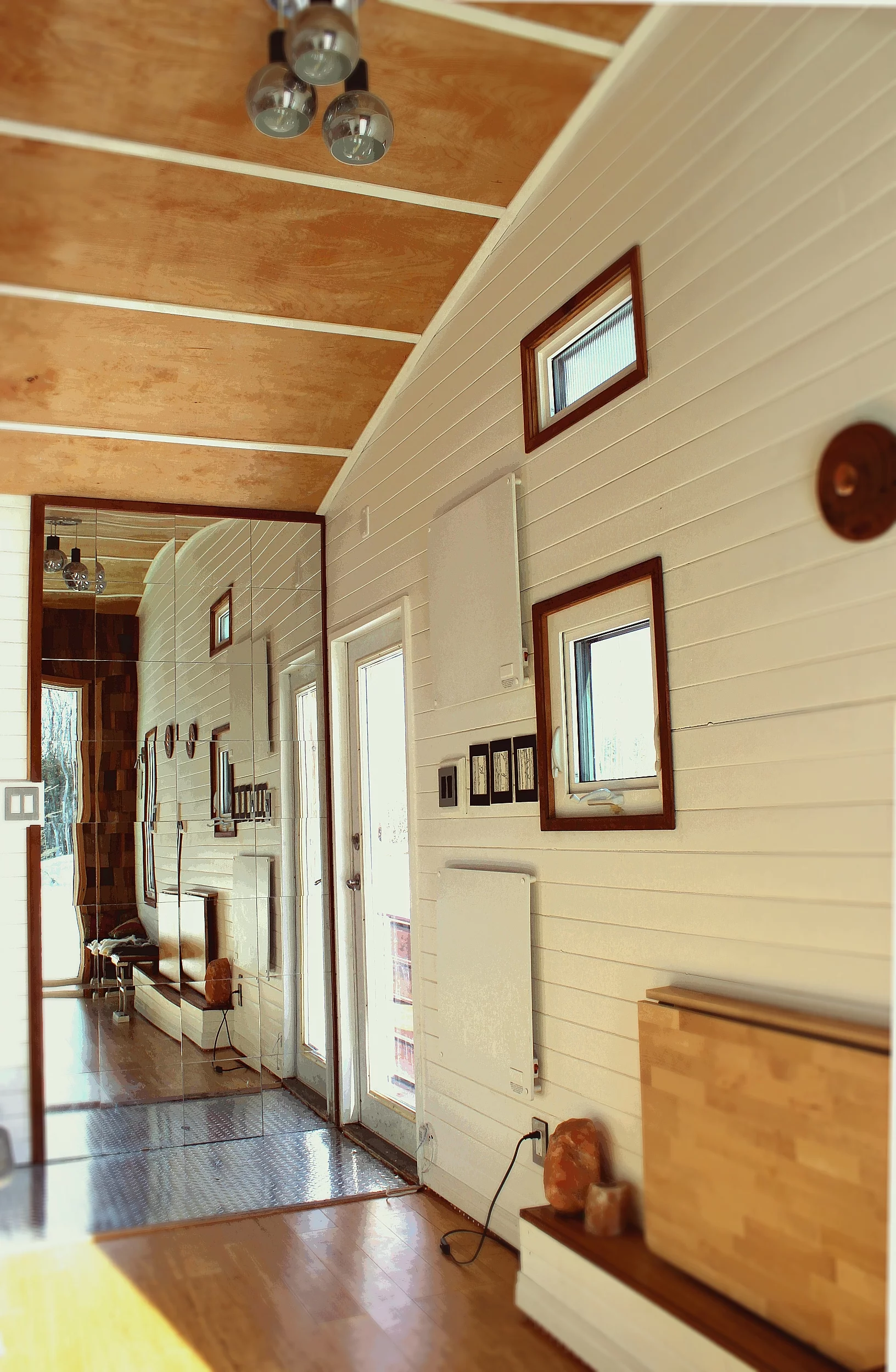 A mirrored wall is installed in a bid to evoke a greater sense of space than there actually is (Photo: Laird Herbert)