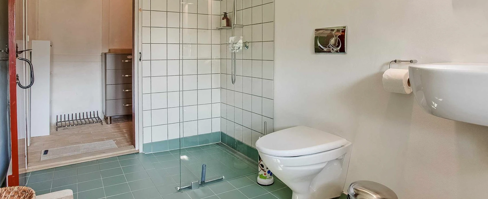 House of Andrine's bathroom includes a shower, toilet, and sink