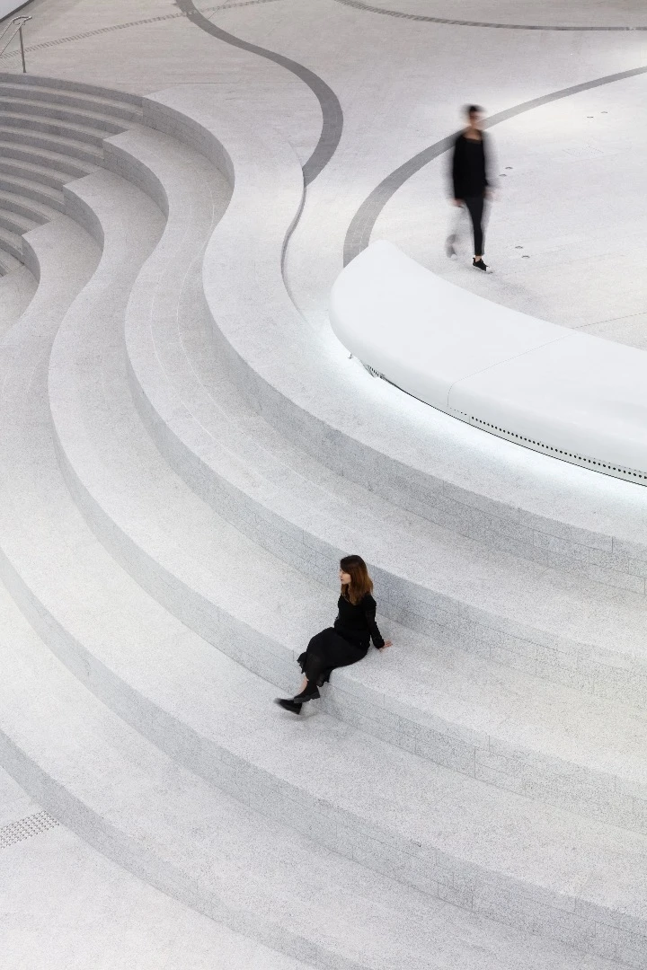 "Qi (meaning flow) is expressed throughout the complex with curvilinear paths and forms and arched entrances designed around a mesmerizing, multi-level circular atrium," says Revery Architecture