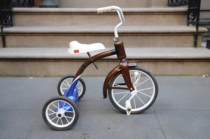New Zealand's Rob Pollock hand-paints clients' bicycle (or tricycle) frames with a faux woodgrain finish