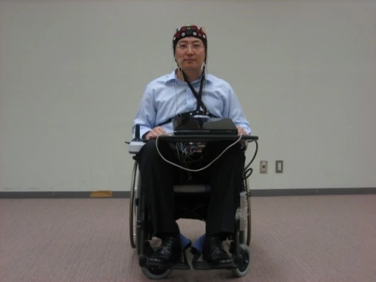 The Toyota/RIKEN wheelchair is fitted with an EEG detector in the form of a electrode array skull cap (Photo: RIKEN)