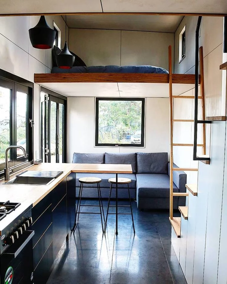The Sowelo tiny house boasts a lower level lounge with sofa bed and lots of natural light