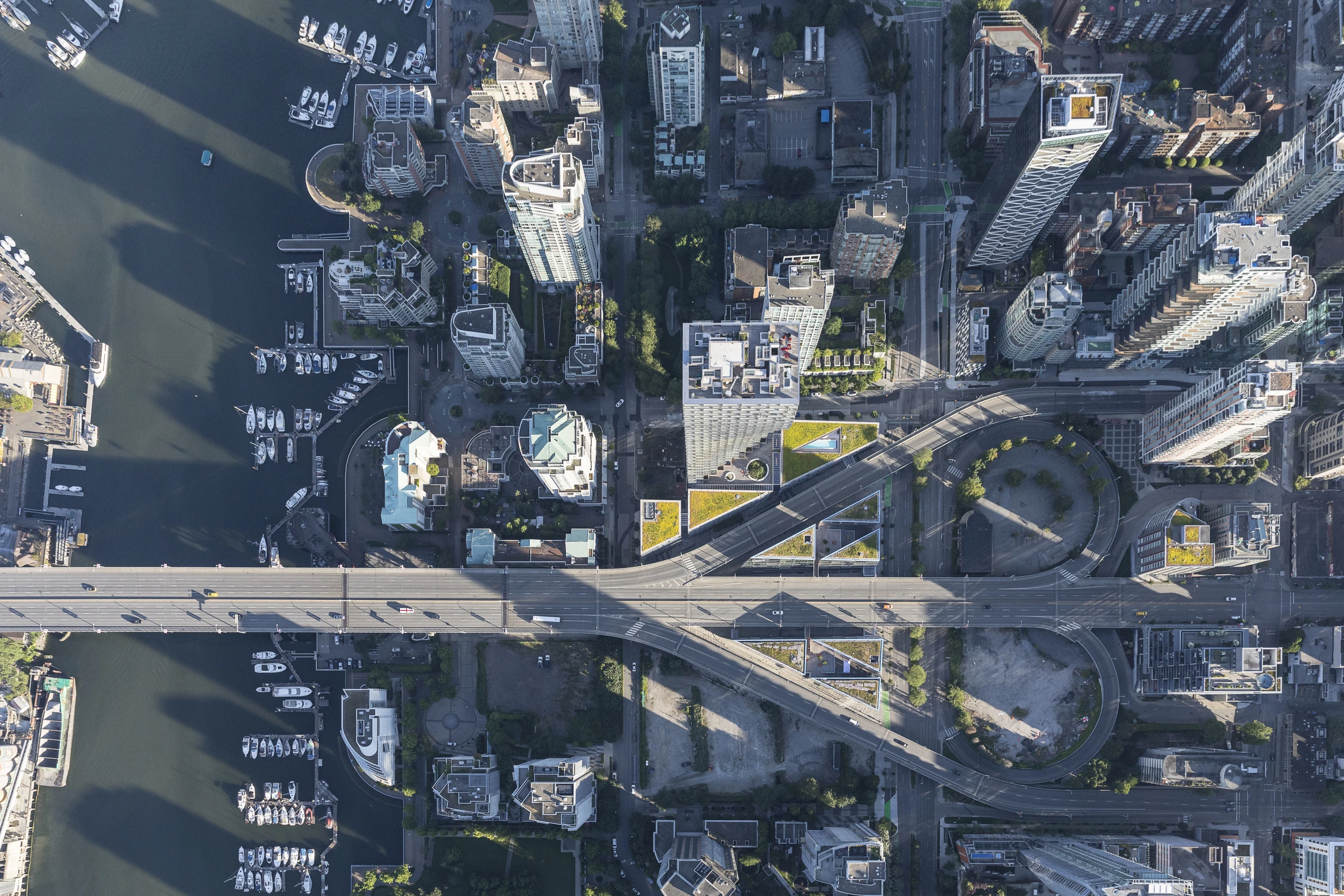 Vancouver House's plot is very small and hemmed-in by the nearby bridge, other buildings, and the river