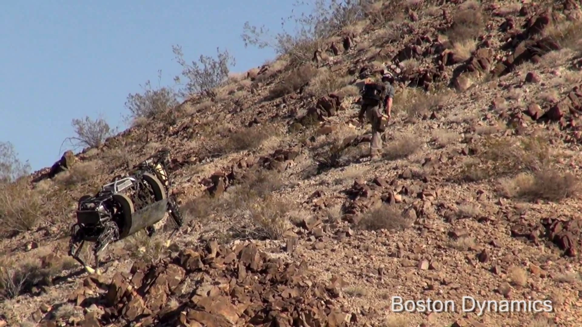 Here, the LS3 follows a human up a steep hill strewn with rocks