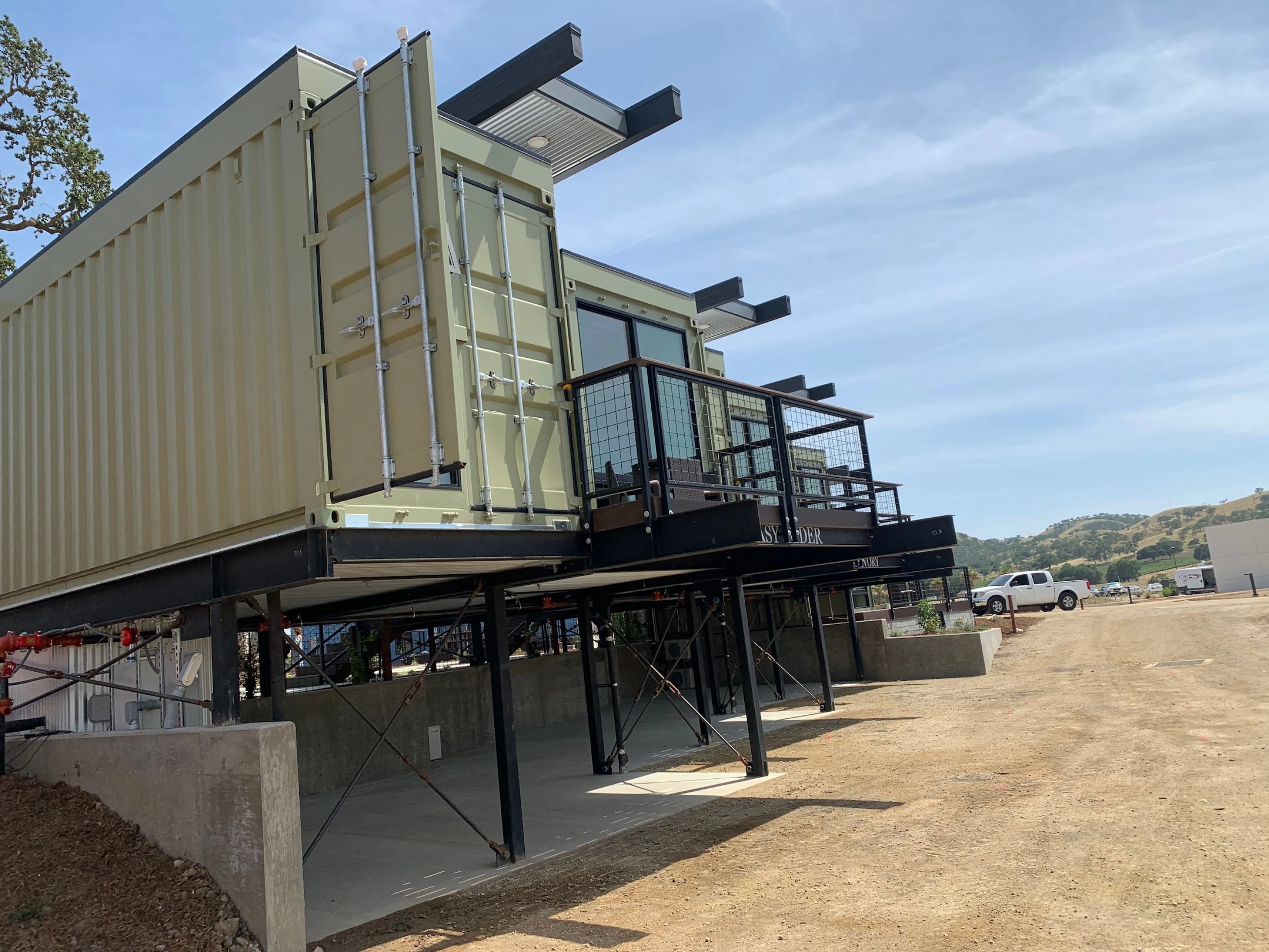 Shipping container hotel raises the roof for light and air