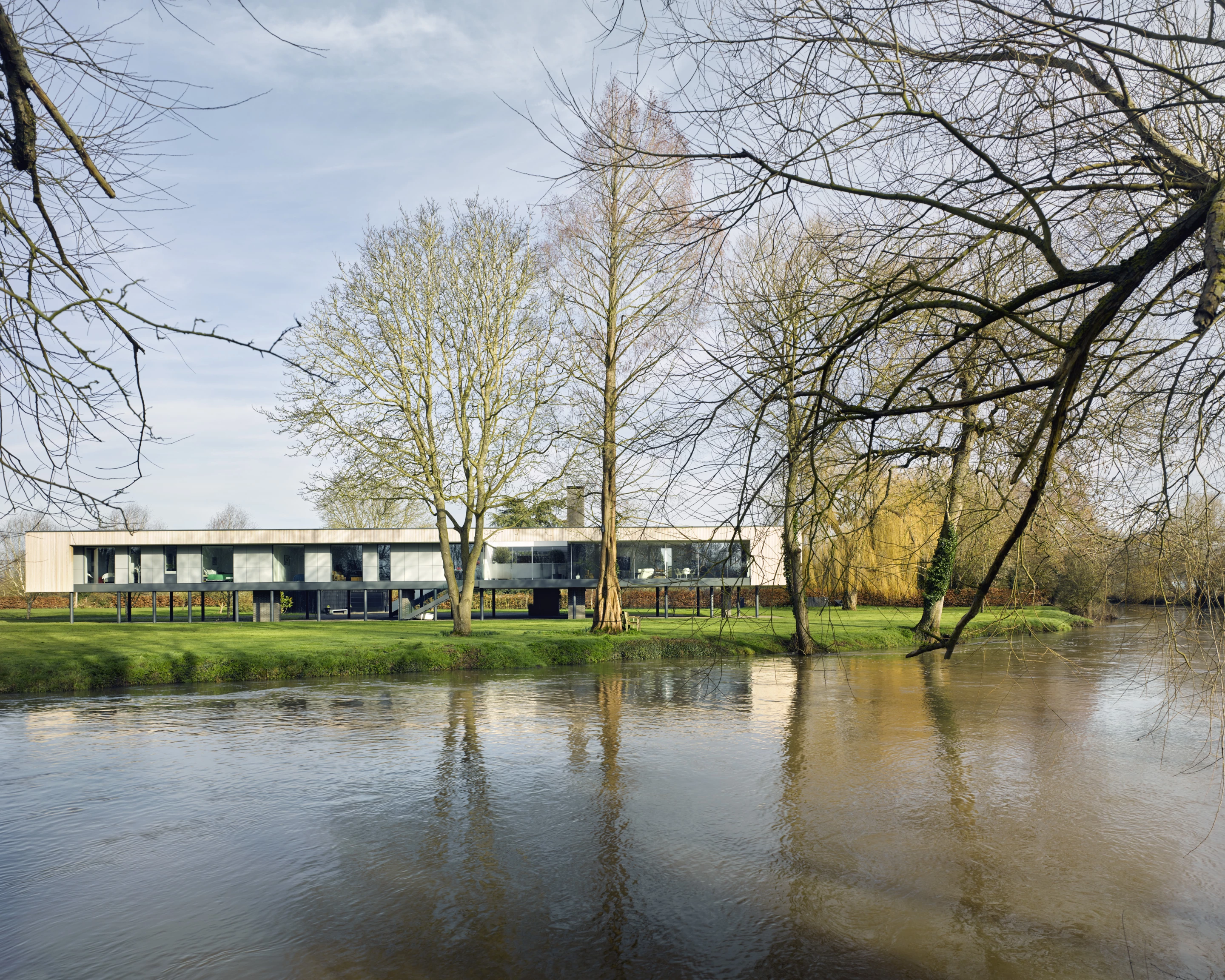 River House was designed by John Pardey Architects and is located in Berkshire. It's situated on a stunning plot on a bend in the River Thames that floods periodically, so to ensure the home is protected from the water it's raised above the ground on stilts