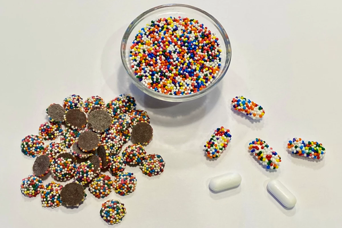 Sprinkle-coated chocolates (left) were used to test the CandyCode concept, although Tylenol caplets (right) also received the sprinkle-coating treatment