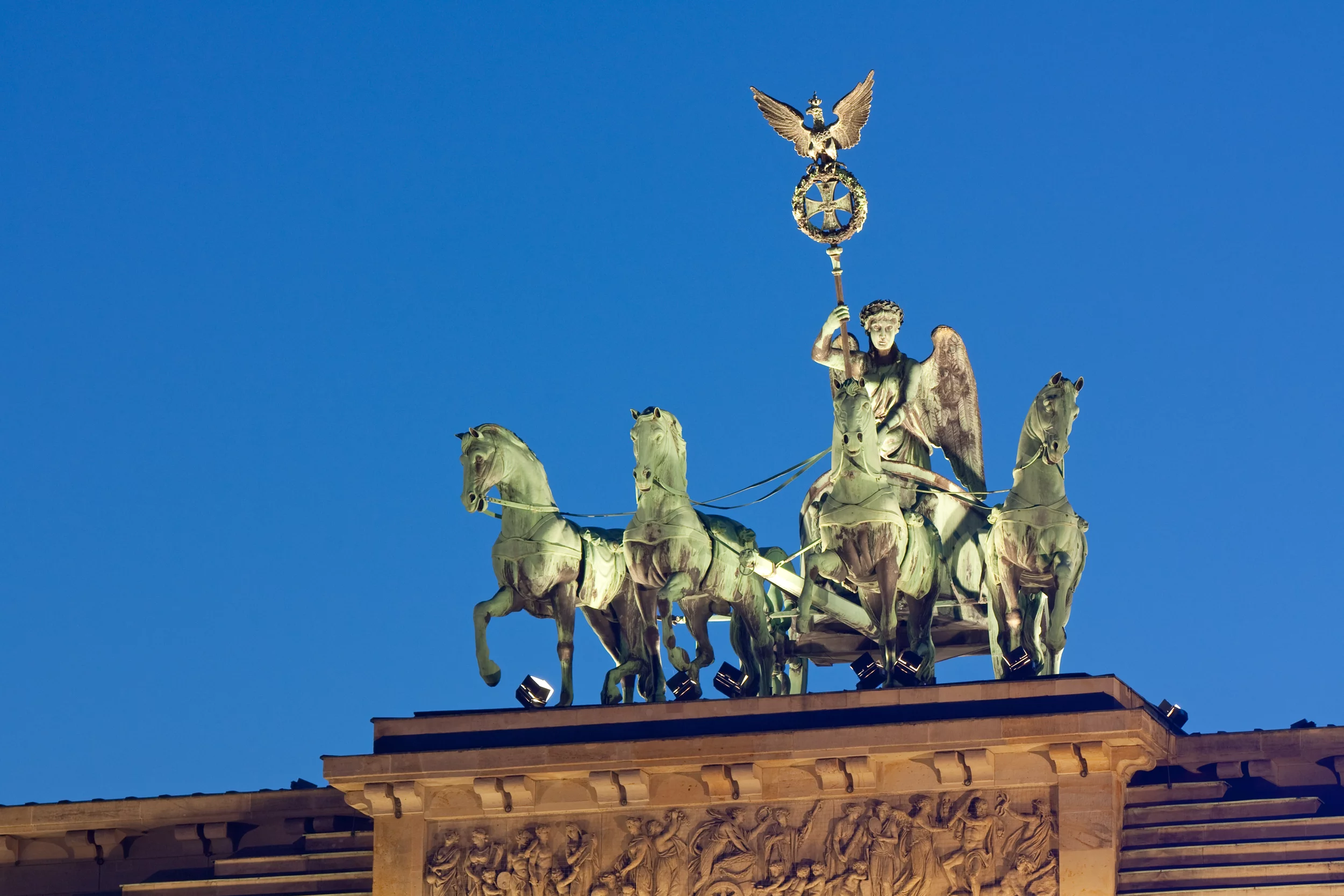 Stock Photo:Quadriga on the Brandenburg Gate (Brandenburger Tor) in Berlin, Germany at night. The sculpture made from copper depicts Victoria, the roman goddess of victory, with a chariot (quadriga).Image ID: 86437777 Release information: N/A Copyright: Thorsten Schier