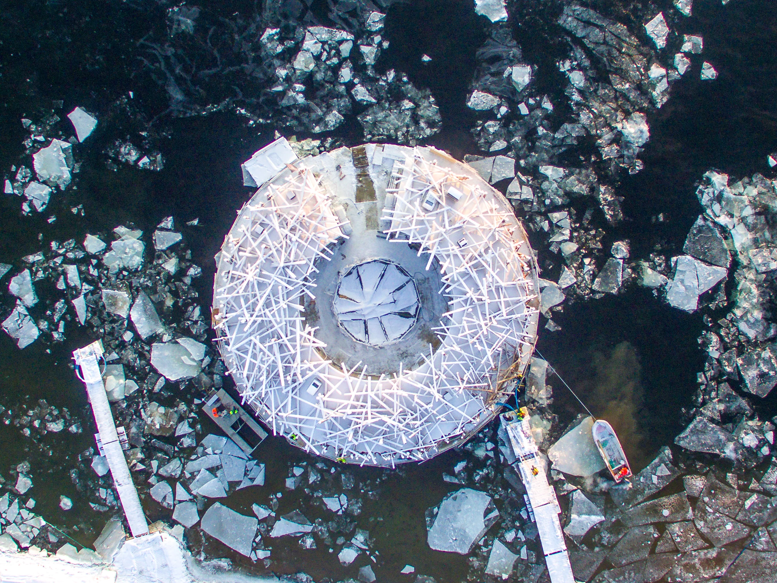 The Arctic Bath's main circular building floats on the river in summer and freezes in place during the harsh winters in Swedish Lapland