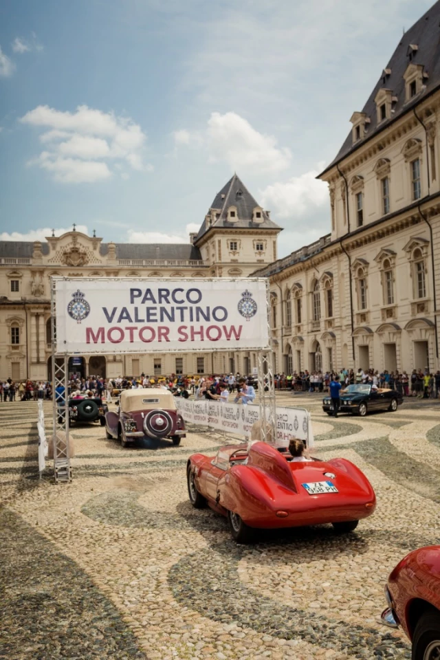 The thirty cars entered in the Parco Valentino Classic enter the Piazza Vittorio Veneto for judging