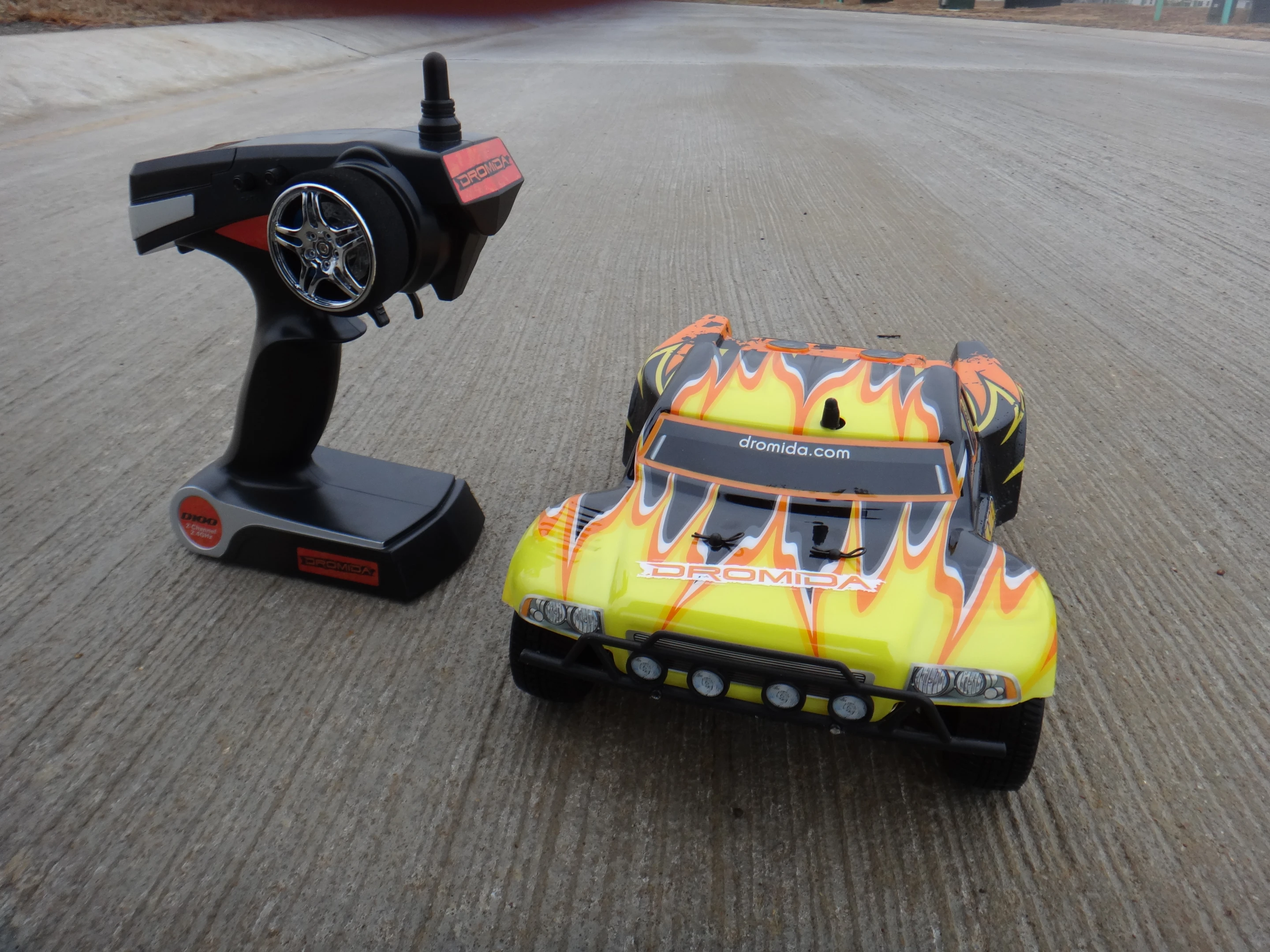 The transmitter's controls are pretty standard, with a small wheel on the side for steering and a trigger for controlling its motion forward and backwards, as well as braking