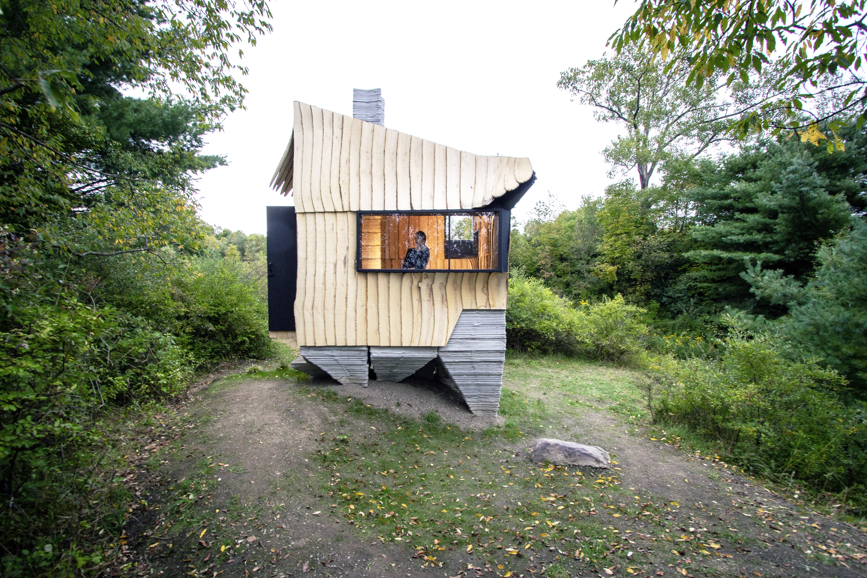Ashen Cabin's concrete base was created with a 3D printer, while its wooden exterior was cut using a robotic arm that was previously used to build cars for General Motors