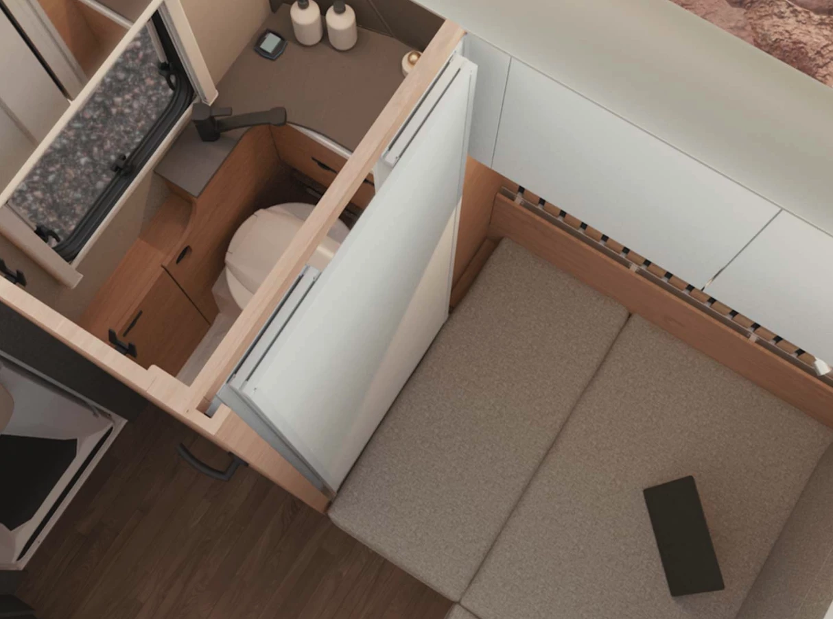 When compacted down the bathroom is a narrow toilet room, but it grows into a larger wet bath with shower via the white interior wall