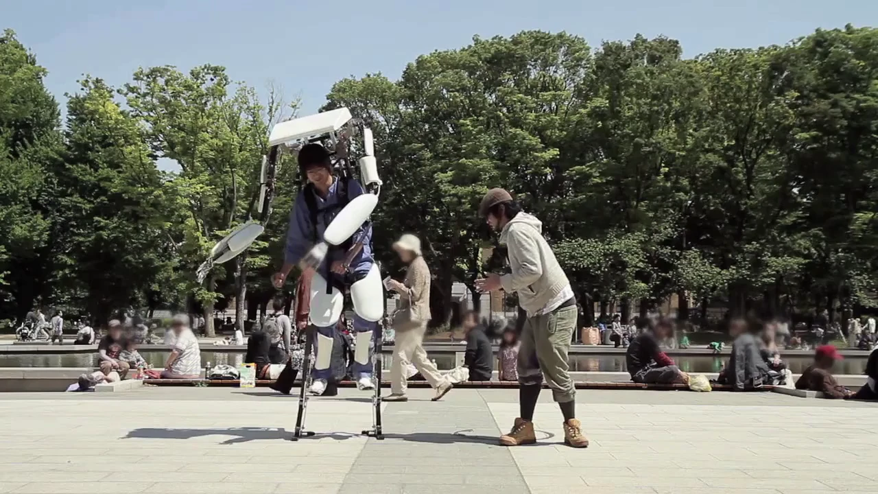 The Power Jacket M3 and a bystander do the "robot" together