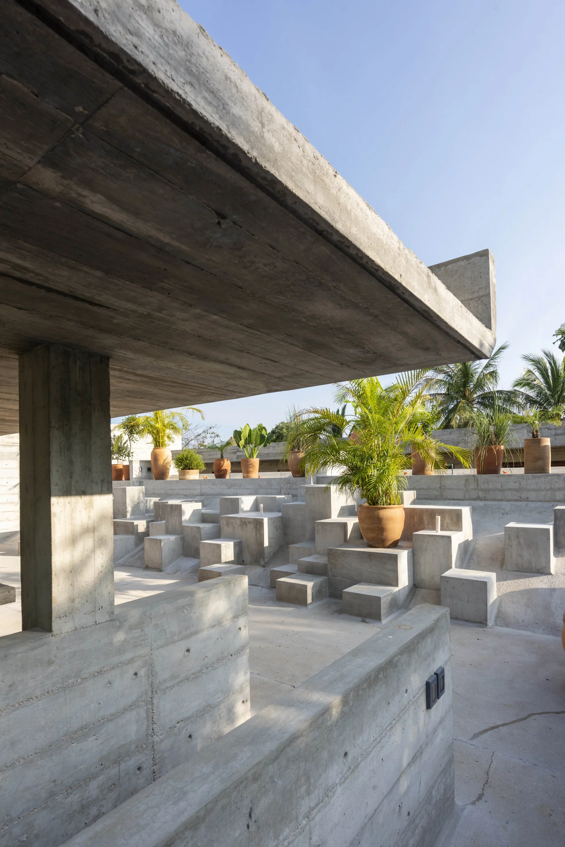 Minimalist concrete volumes create an outdoor retreat for guests