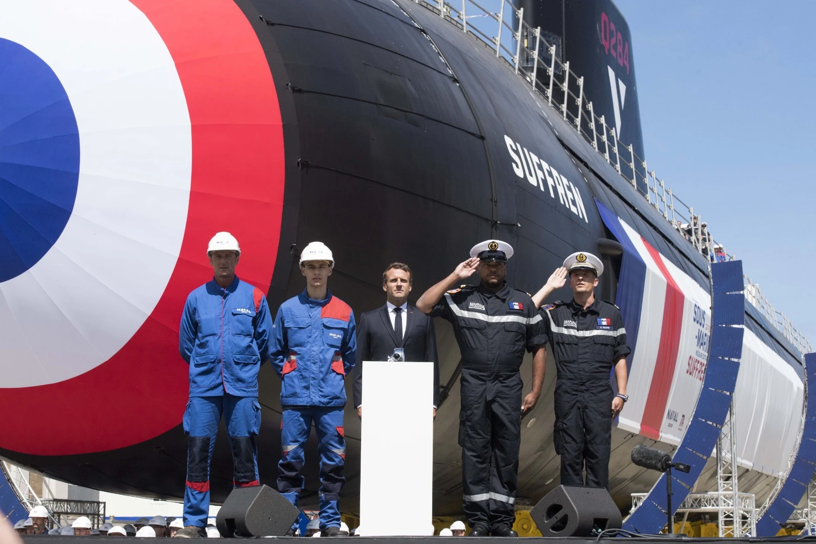 Naval Group employees and sailors in front of the Suffren with the President Macron