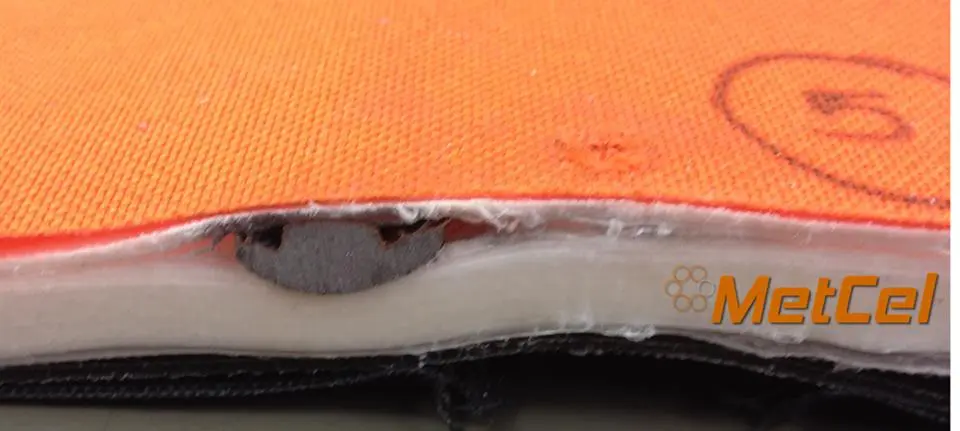 Close-up of a 9mm bullet caught in the layers of the Bodyguard Blanket