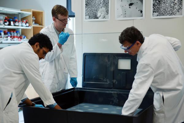 The new transparent aerogel is settled on a pane of glass in a tub