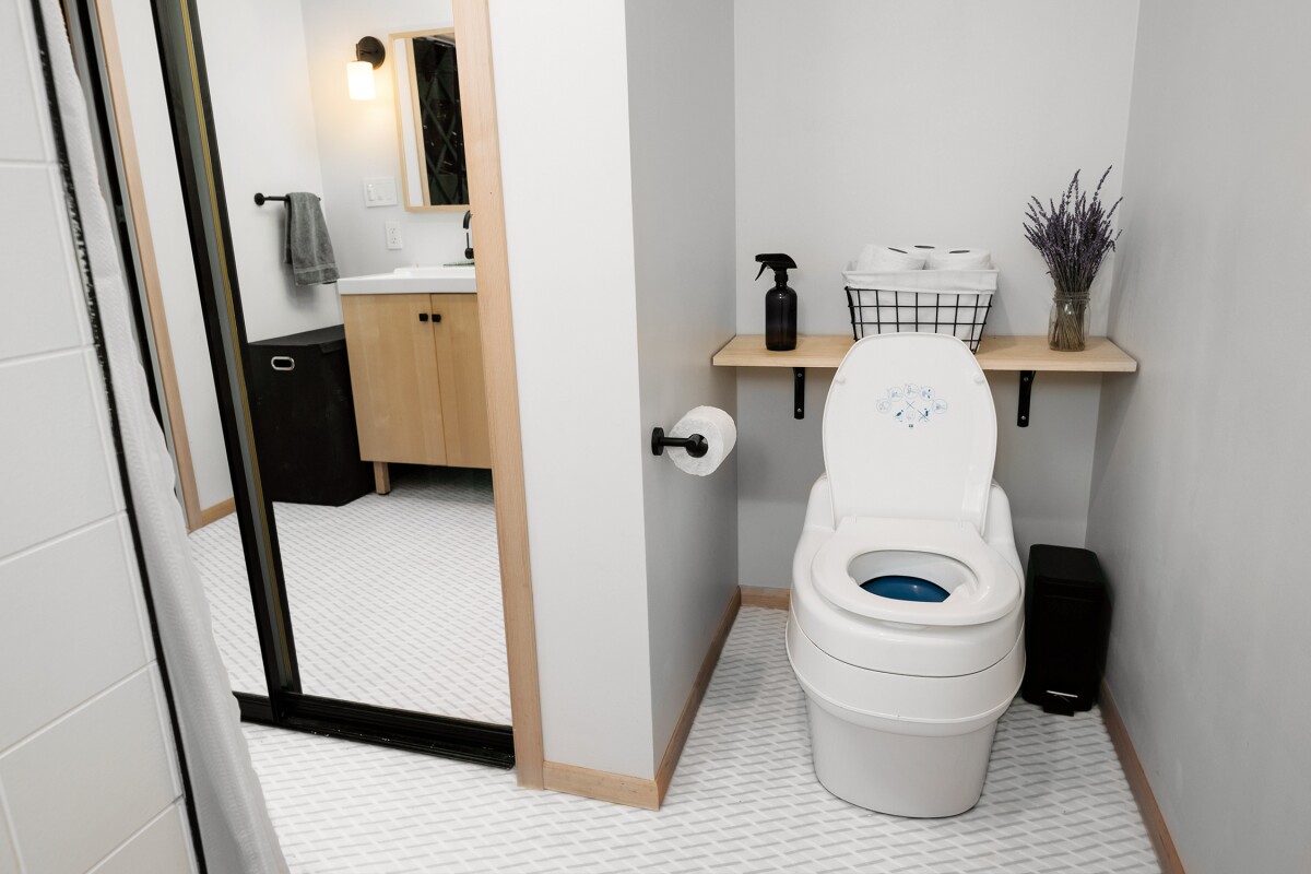 The bathroom features a composting toilet