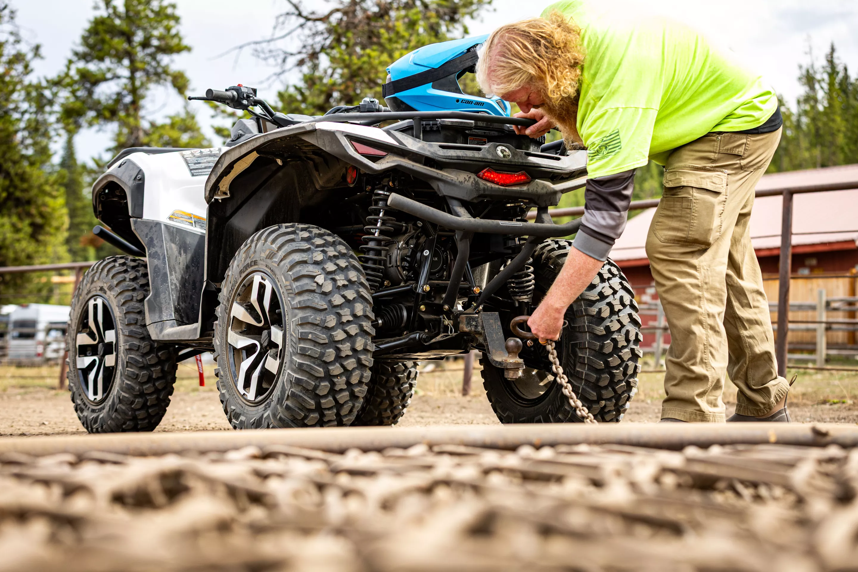 Hitching up an arena groomer to the Can-Am Outlander Electric, the author prepares to drag a horse arena on a ranch in Wyoming
