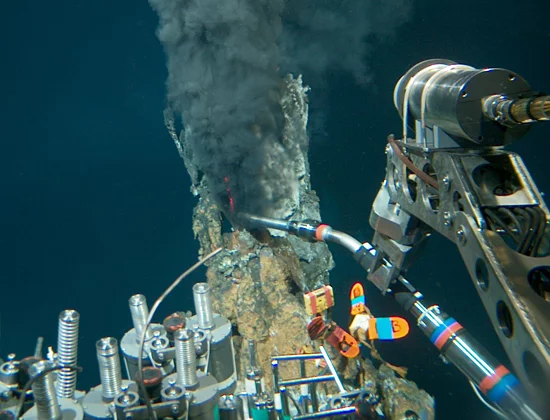 Alvin's manipulator taking readings from a deep sea thermal vent