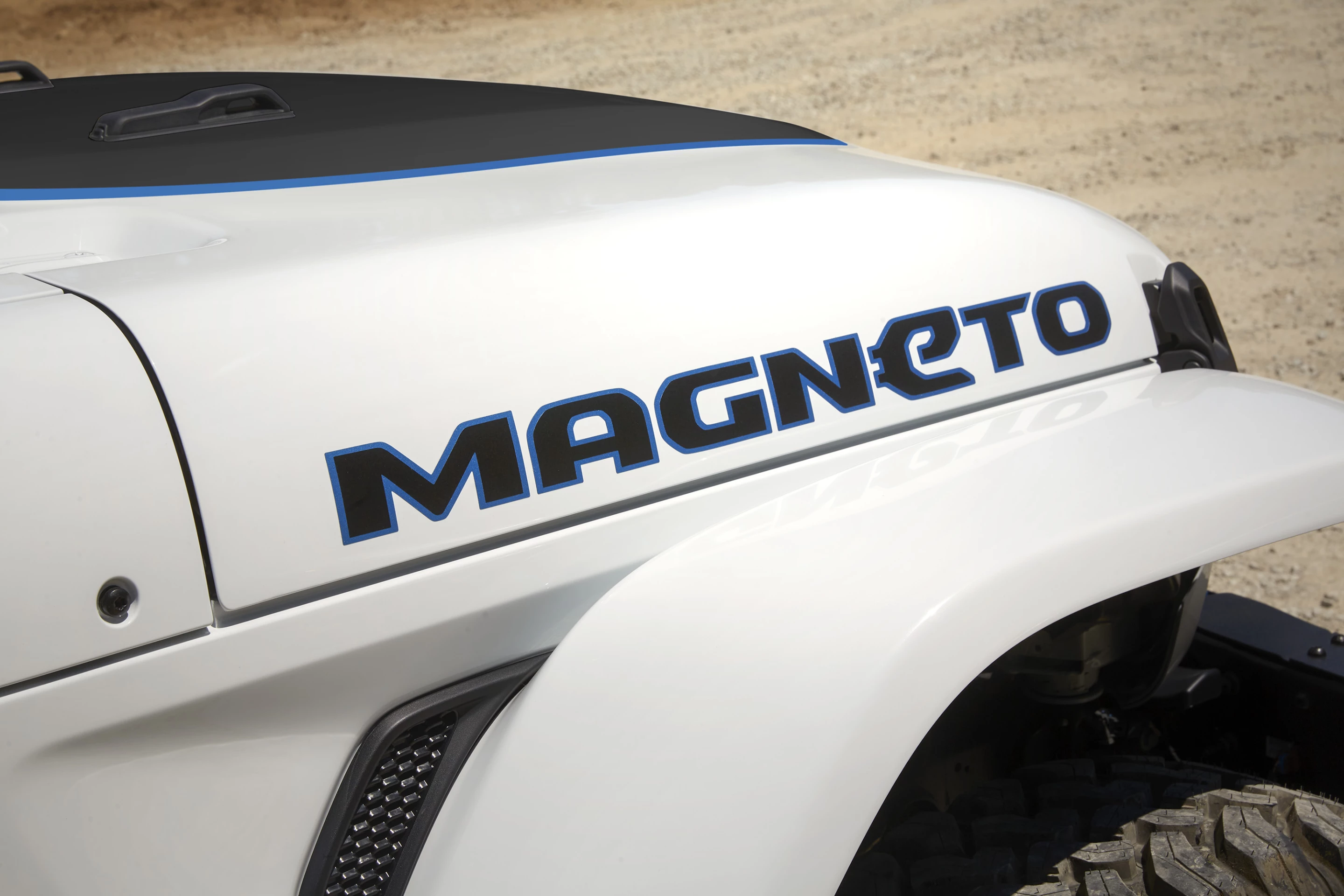 The Jeep Magneto BEV concept wears bright white paint with "surf blue" accents and includes a custom "Magneto" decal to distinguish it from other Wranglers