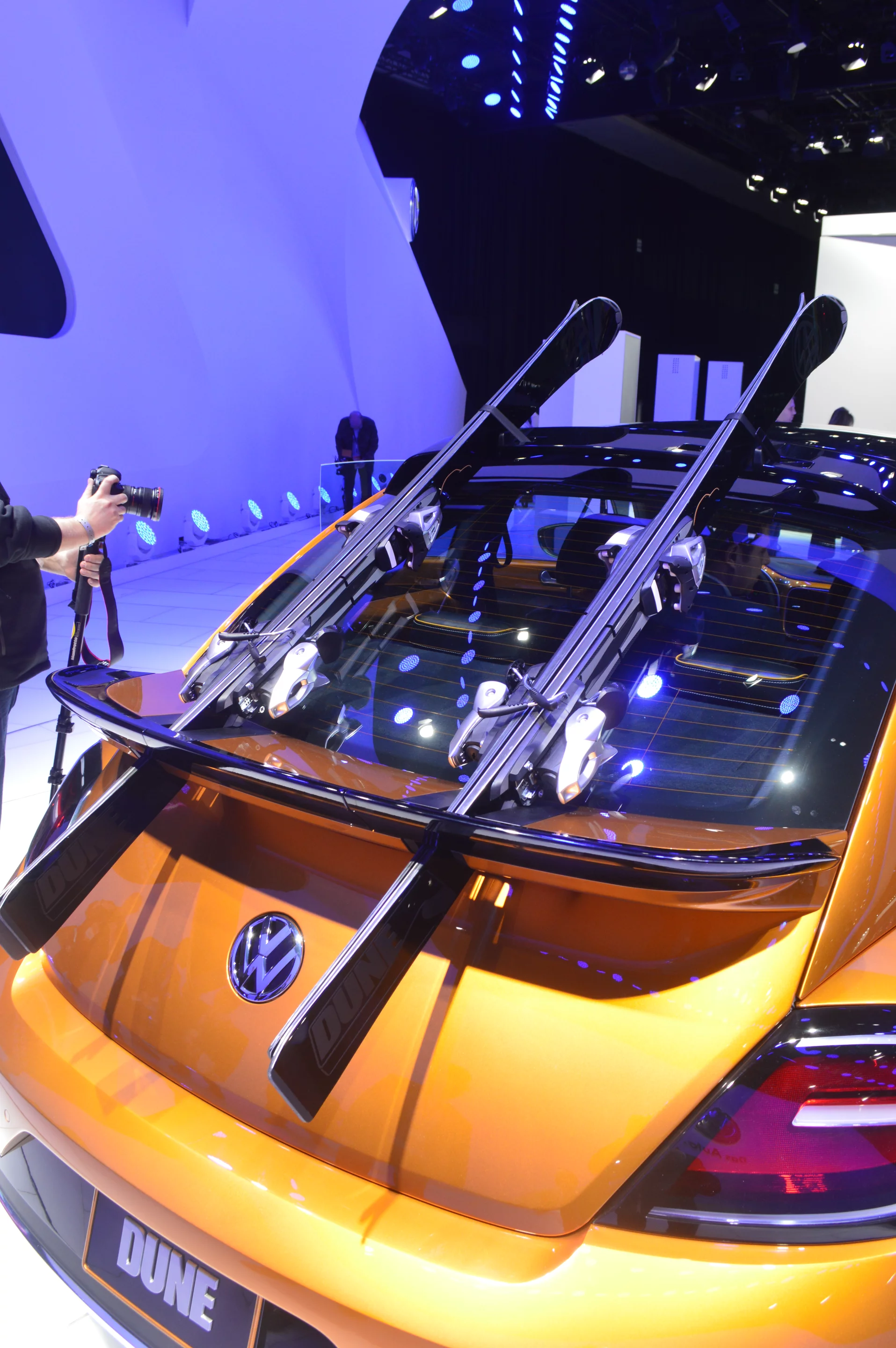 In the rear, skis can be carried on the trunk lid by swiveling the outer portions of the spoiler out of the way, placing the skis beneath those portions, then swiveling them back to hold the skis in place