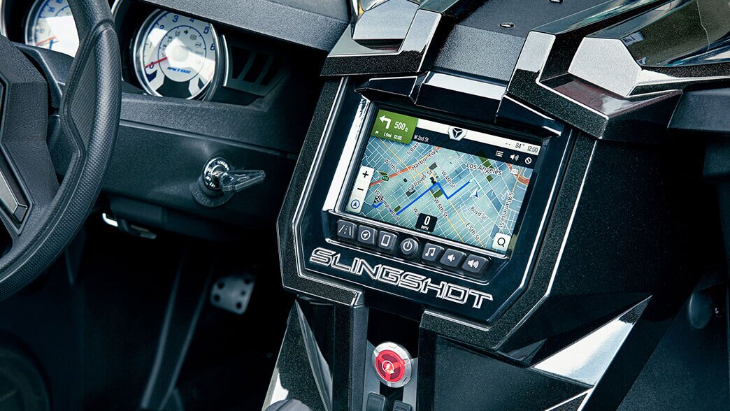 The Polaris Slingshot Grand Touring's 7-inch Ride Command Display multitouch infotainment system offers features such as turn-by-turn navigation, Bluetooth/USB smartphone connectivity, a 100-watt Rockford Fosgate audio system, and the output from a rear back-up camera