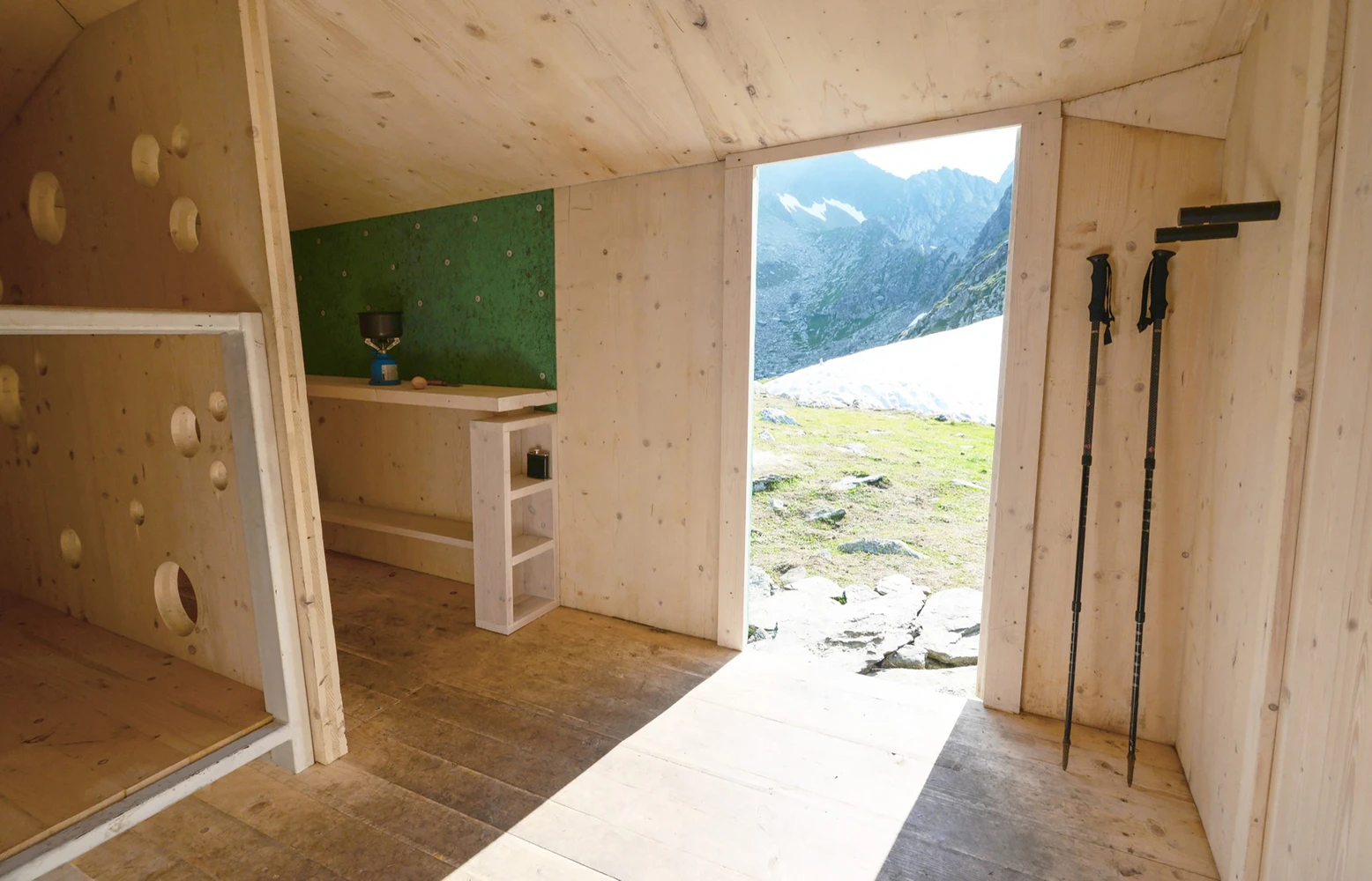 The interior is split between a cooking area with a stove, a 19-person space that's open to anyone exploring the mountains, and a smaller 3-person space
