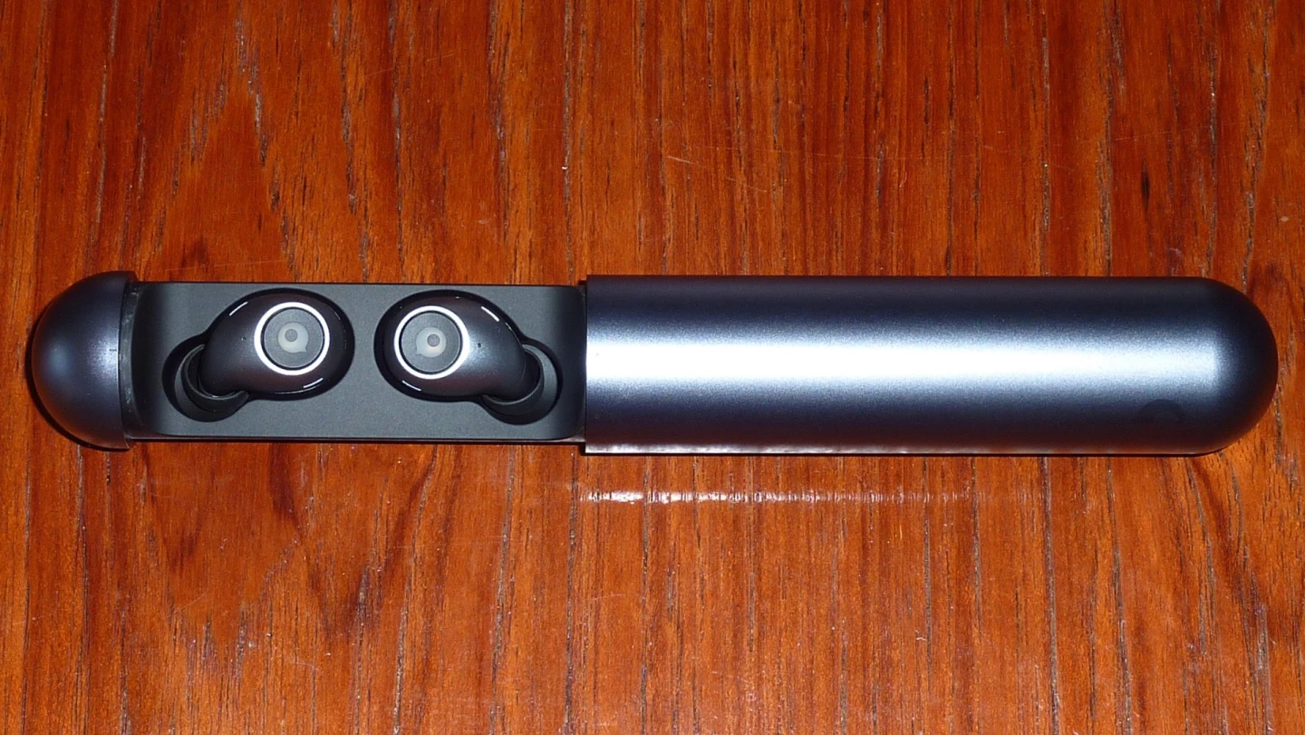 The Crazybaby 1S earbuds inside their portable charging capsule
